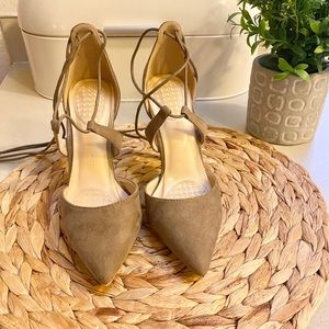 Brown lace-up heels with a pointed toe